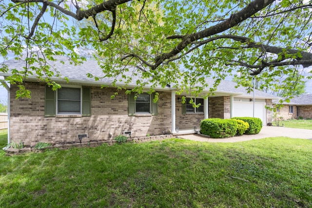 ranch-style house featuring brick siding, a front lawn, and an attached garage
