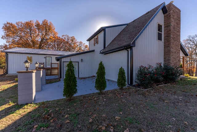 back of house featuring a patio and a chimney