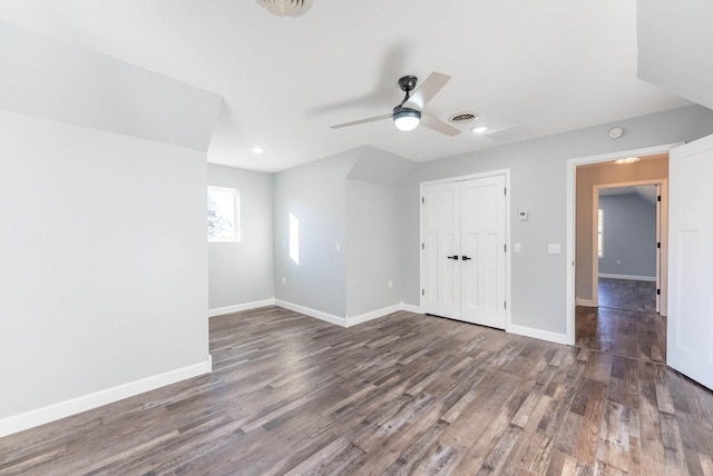 unfurnished bedroom featuring visible vents, baseboards, wood finished floors, and a closet