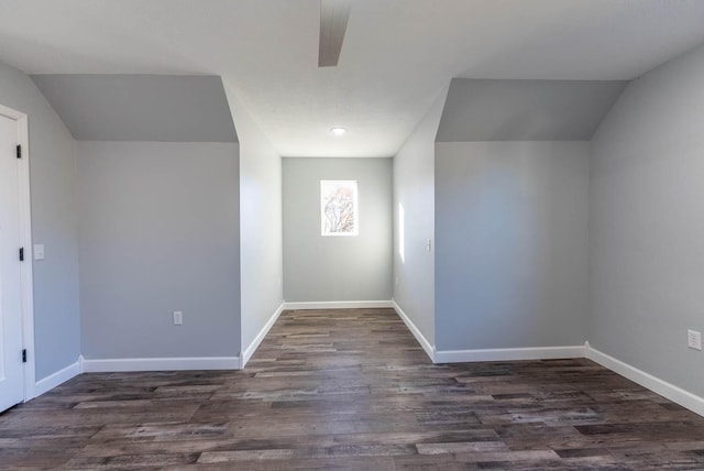 bonus room featuring baseboards, a ceiling fan, lofted ceiling, and dark wood-style floors