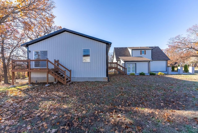 view of home's exterior featuring stairs and a wooden deck