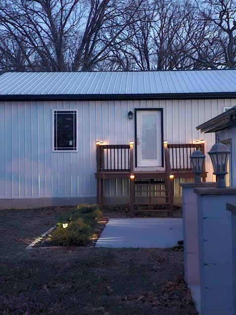 410 White Oak Dr, El Dorado Springs, MO 64744 - view of exterior entry featuring board and batten siding and metal roof