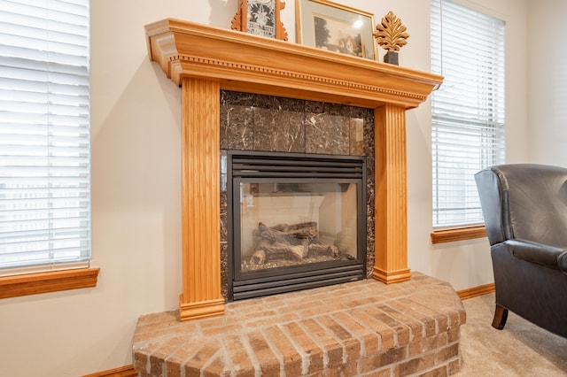 room details with baseboards, a fireplace, and carpet flooring