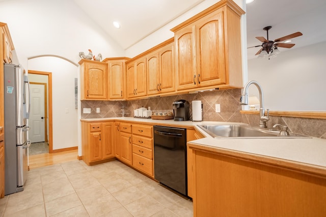 kitchen featuring a sink, black dishwasher, a ceiling fan, freestanding refrigerator, and backsplash