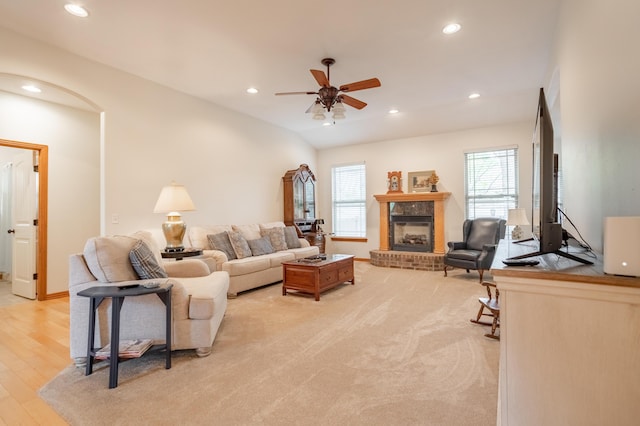 living area featuring a brick fireplace, recessed lighting, ceiling fan, and a healthy amount of sunlight