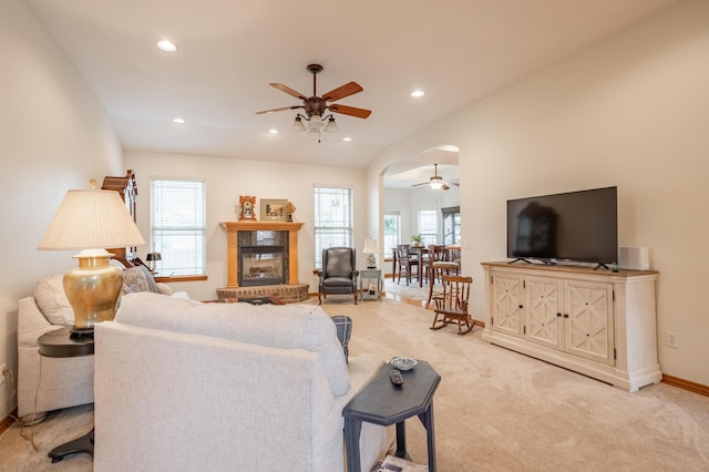 living area with a fireplace, a ceiling fan, recessed lighting, and light colored carpet