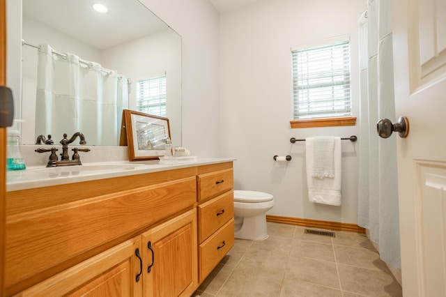 bathroom featuring visible vents, tile patterned flooring, vanity, baseboards, and toilet