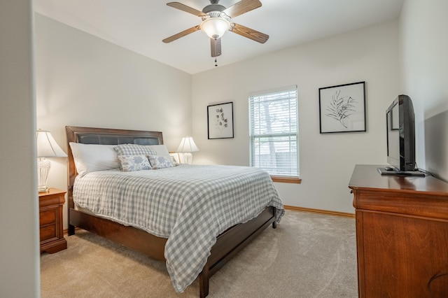carpeted bedroom featuring baseboards and ceiling fan