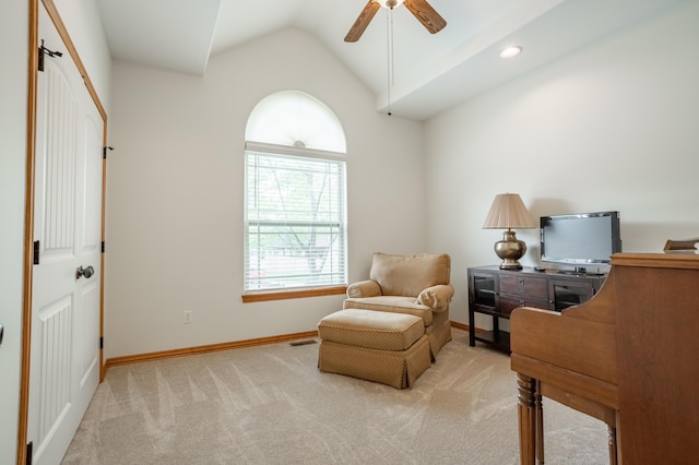 sitting room with a ceiling fan, visible vents, vaulted ceiling, baseboards, and carpet flooring