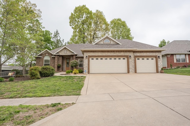 view of front of house with brick siding, driveway, a front yard, and a garage