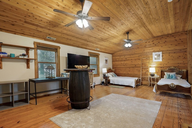 121 Waverly St, Hollister, MO 65672 - bedroom featuring visible vents, lofted ceiling, wooden walls, wood ceiling, and hardwood / wood-style flooring