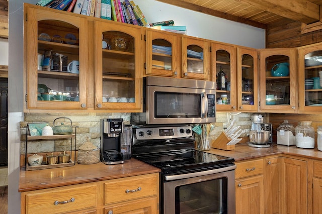 121 Waverly St, Hollister, MO 65672 - kitchen with stainless steel appliances, decorative backsplash, wood ceiling, and glass insert cabinets