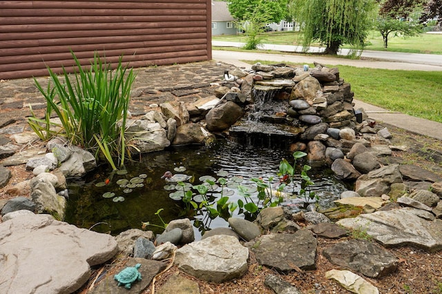 121 Waverly St, Hollister, MO 65672 - details with a garden pond and faux log siding