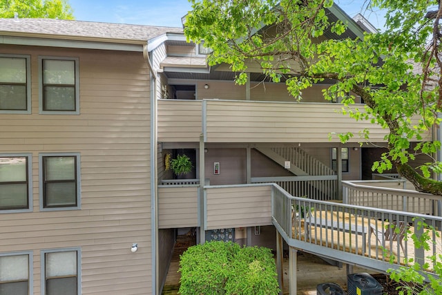 rear view of property featuring stairway