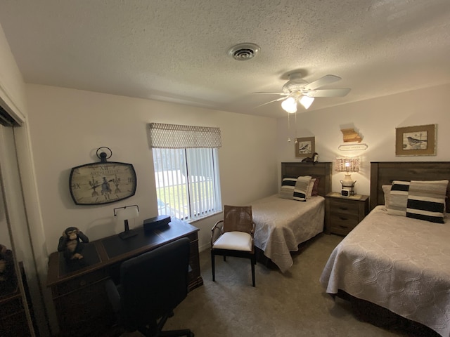 carpeted bedroom with a ceiling fan, a textured ceiling, and visible vents