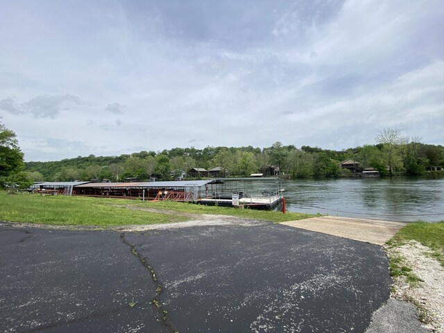 dock area featuring a water view and a wooded view