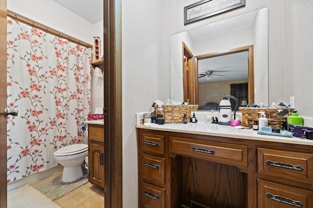 bathroom featuring a textured wall, tile patterned flooring, vanity, toilet, and a shower with curtain