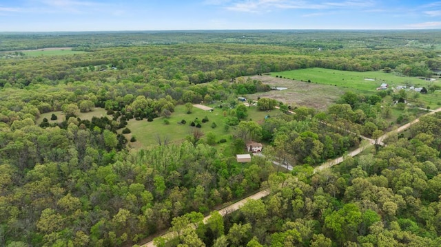 birds eye view of property with a view of trees