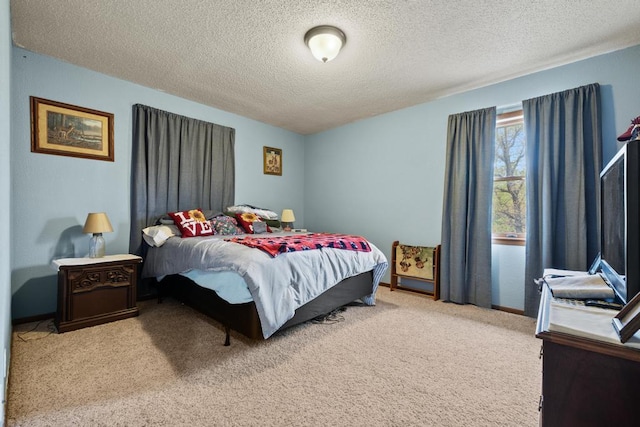 bedroom featuring a textured ceiling and carpet
