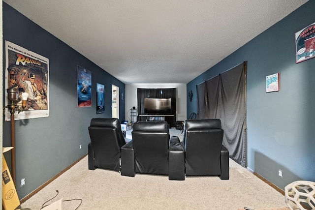 home theater room with carpet floors, baseboards, and a textured ceiling