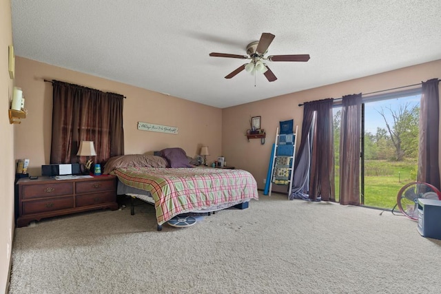 bedroom featuring a ceiling fan, a textured ceiling, and carpet