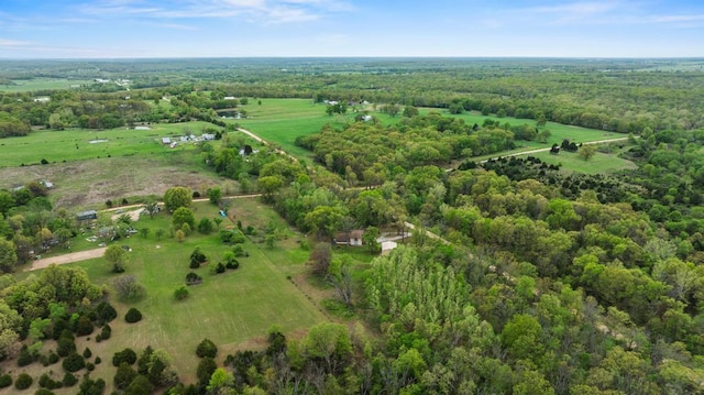 bird's eye view featuring a view of trees and a rural view