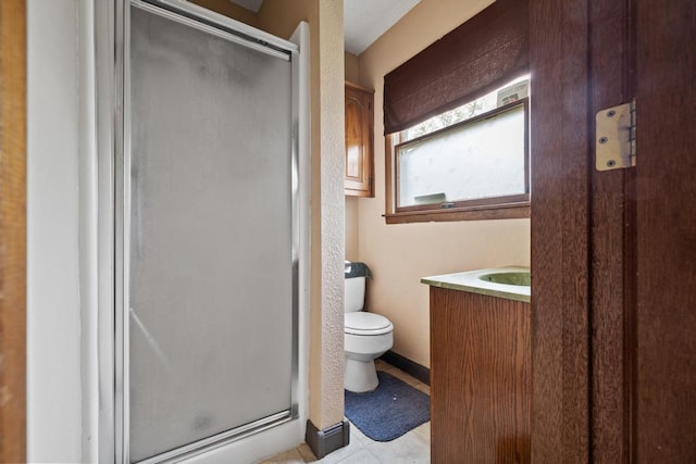 full bathroom with vanity, tile patterned flooring, a shower stall, and toilet