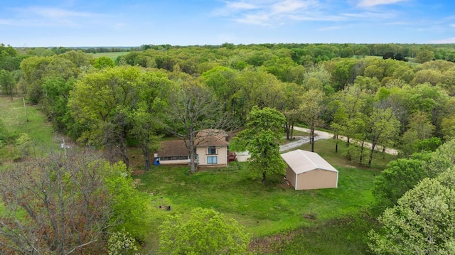 birds eye view of property with a view of trees