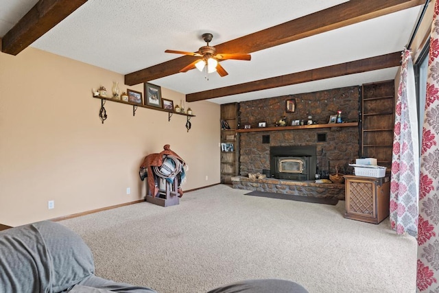 carpeted living room featuring baseboards, beamed ceiling, a ceiling fan, and a textured ceiling