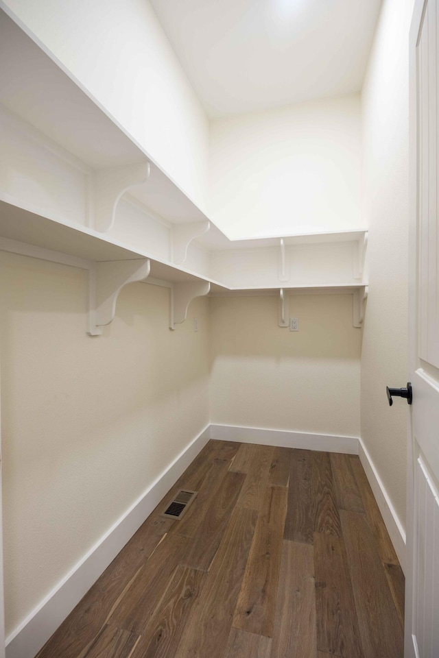 walk in closet featuring visible vents and dark wood-style floors