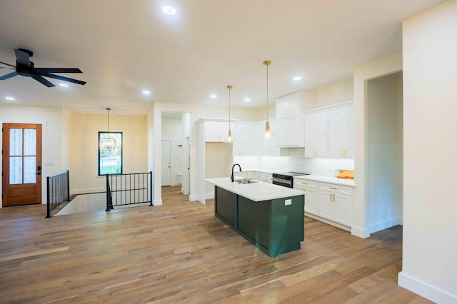 kitchen featuring light wood-style floors, recessed lighting, white cabinets, and tasteful backsplash