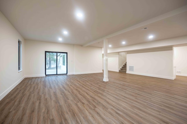 below grade area with recessed lighting, baseboards, stairs, and wood finished floors