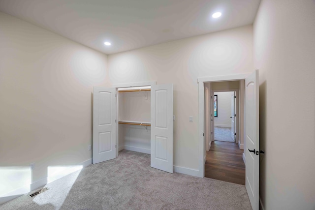 unfurnished bedroom with visible vents, carpet flooring, baseboards, and recessed lighting