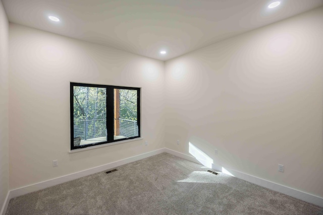 carpeted empty room with recessed lighting, baseboards, and visible vents