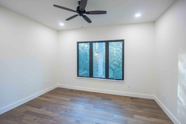 spare room featuring a ceiling fan, baseboards, recessed lighting, wood finished floors, and visible vents