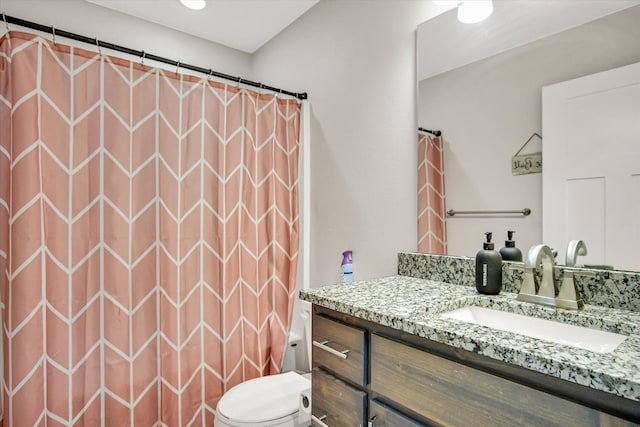 full bath with vanity, toilet, and curtained shower