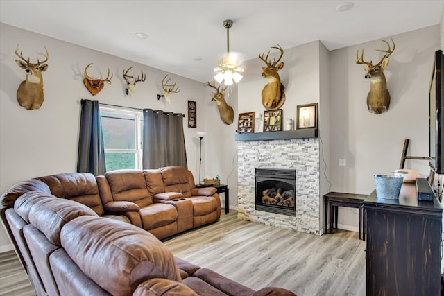 living room with light wood finished floors and a fireplace