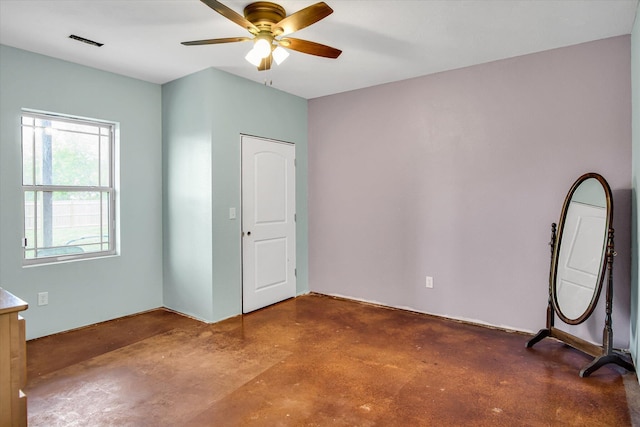 unfurnished bedroom with visible vents, a ceiling fan, and finished concrete flooring