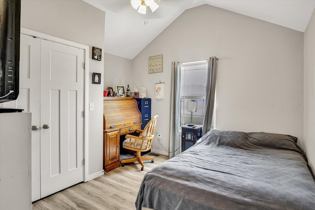 bedroom featuring a ceiling fan, baseboards, vaulted ceiling, and light wood-style flooring