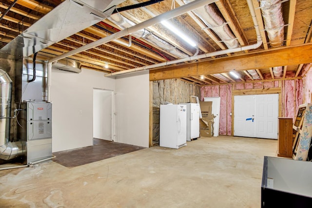 unfinished basement featuring freestanding refrigerator and heating unit