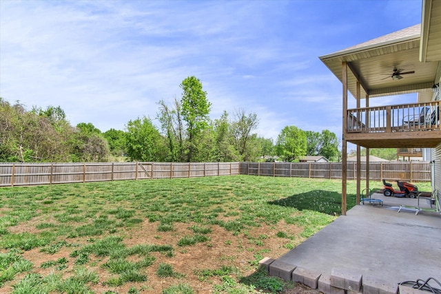 view of yard with a fenced backyard, ceiling fan, and a patio area
