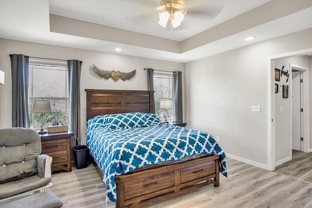bedroom with light wood-type flooring, recessed lighting, and baseboards
