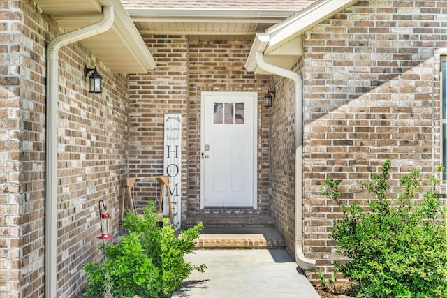 property entrance featuring brick siding