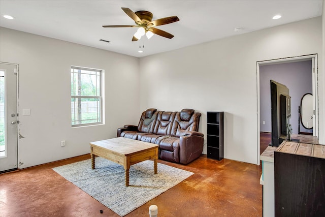 living area with finished concrete flooring, a ceiling fan, recessed lighting, and visible vents