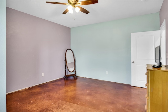 unfurnished room with ceiling fan and finished concrete floors