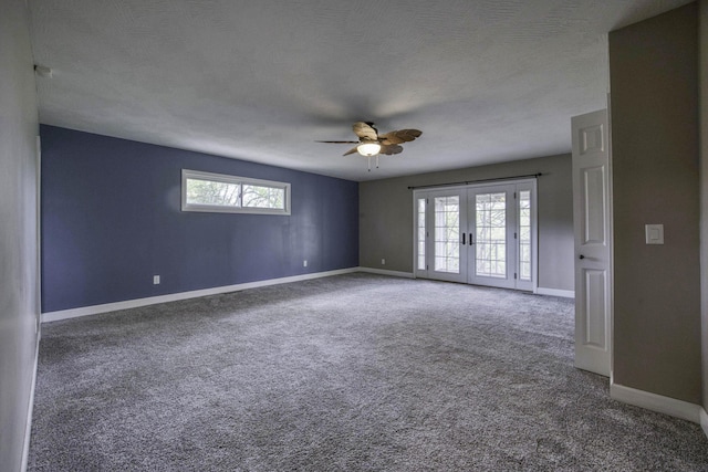 carpeted empty room with baseboards, ceiling fan, french doors, and a wealth of natural light