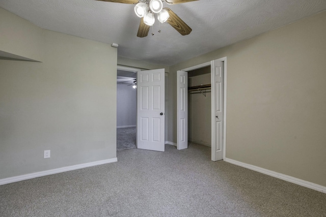 unfurnished bedroom featuring a closet, baseboards, a ceiling fan, and carpet flooring