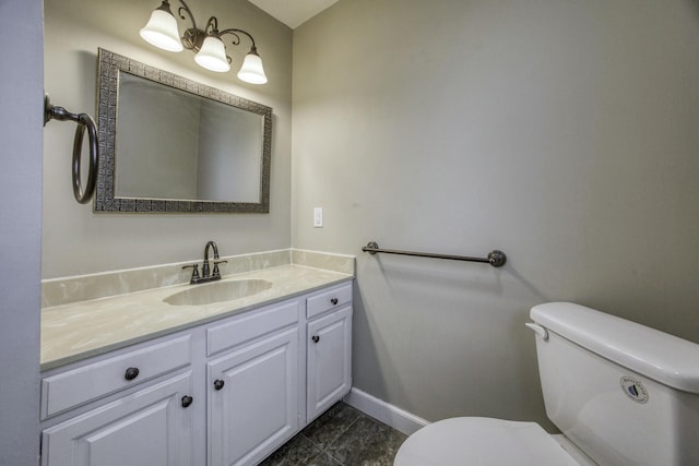 bathroom featuring toilet, baseboards, tile patterned flooring, and vanity