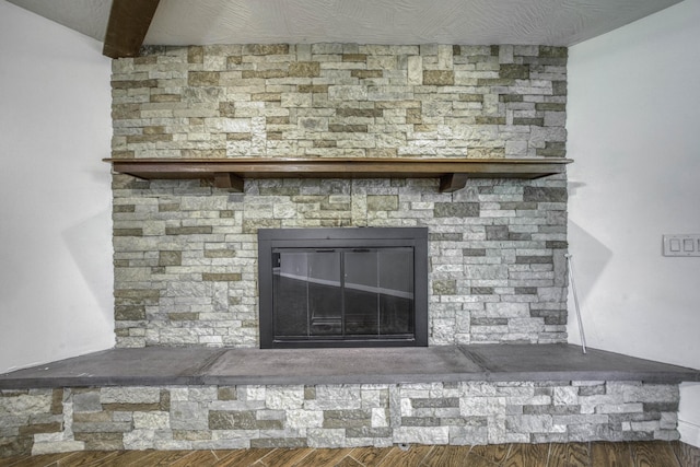 interior details with wood finished floors and a fireplace