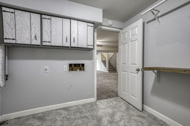 washroom featuring baseboards, hookup for a washing machine, cabinet space, and electric dryer hookup